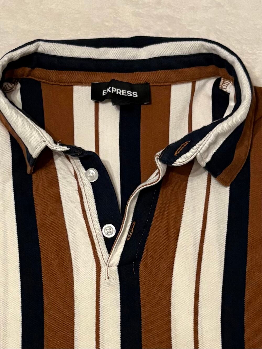 Men’s express polo brown, blue, and cream stripe. Size medium.